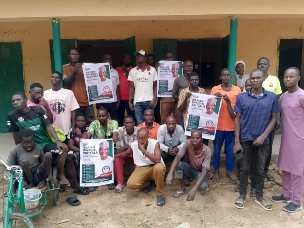 Youth supporters holding a large campaign banner for Professor Vahyala