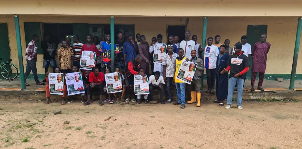 Large youth gathering with campaign posters